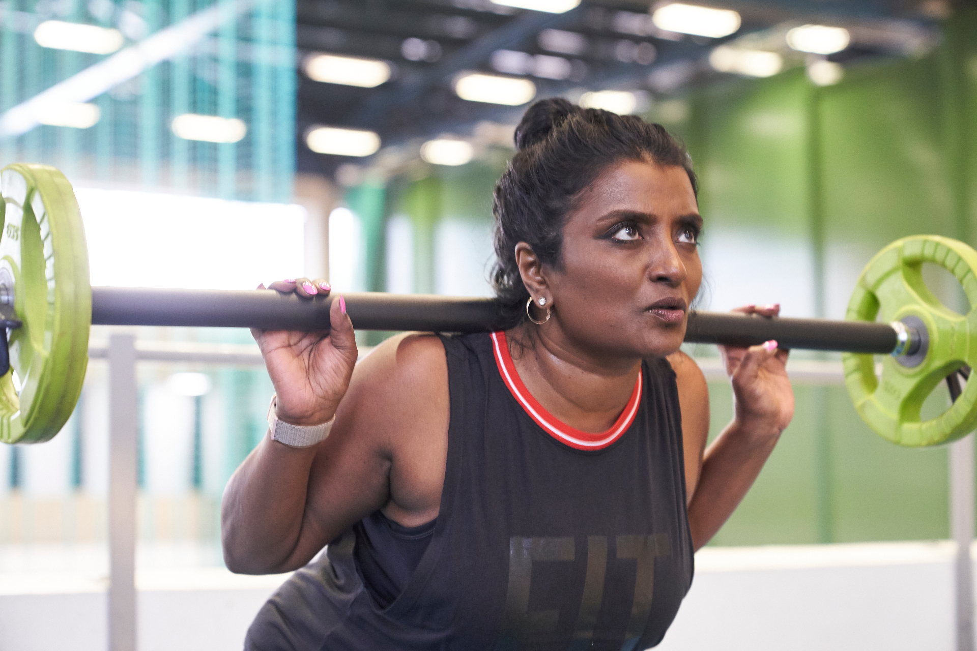 Grassroots athlete training with a barbell at a community gym
